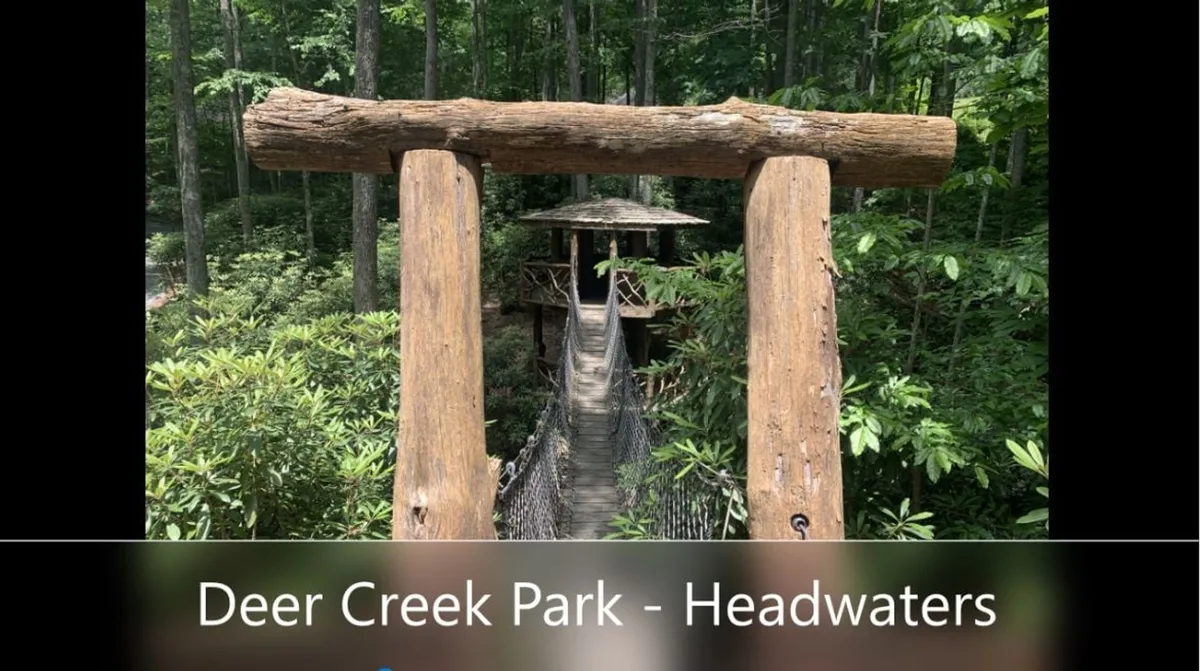 A picturesque suspension bridge surrounded by lush greenery and wooded landscape, inviting exploration and adventure. The scene exudes a sense of discovery and connection with nature, ideal for hikes and outdoor recreation.