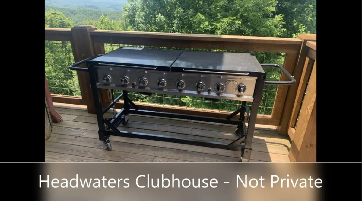 An outdoor grill is set against a backdrop of rolling mountains, with ample space for gatherings. The area is designed for social cooking and outdoor feasts, featuring both the grill and a stunning natural view that encourages group activities and memorable moments.